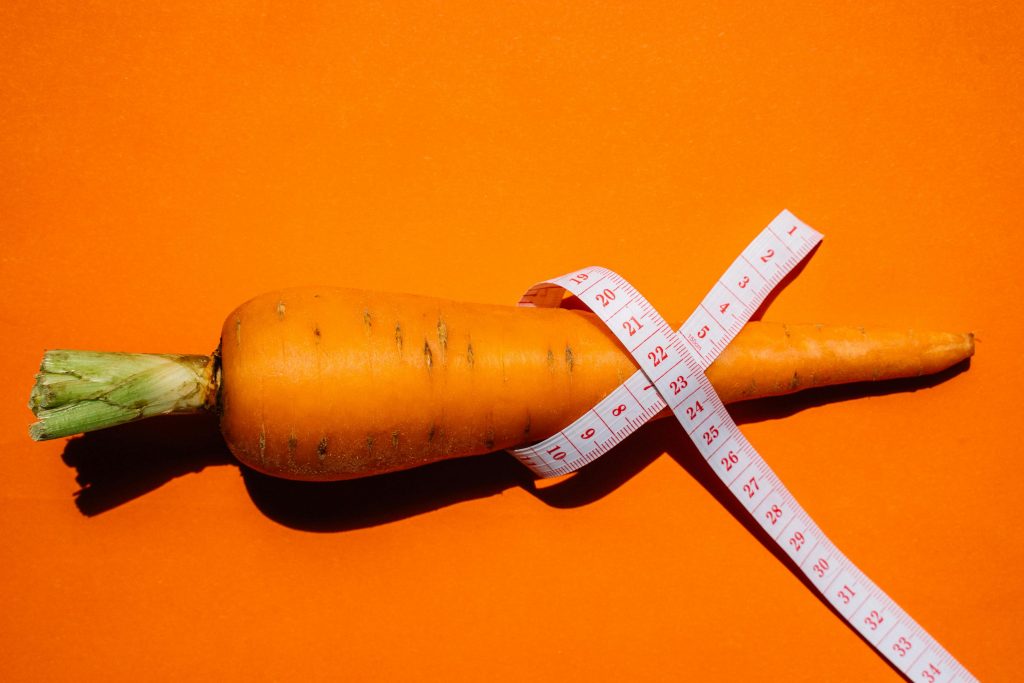 Measuring tape wrapped around a carrot