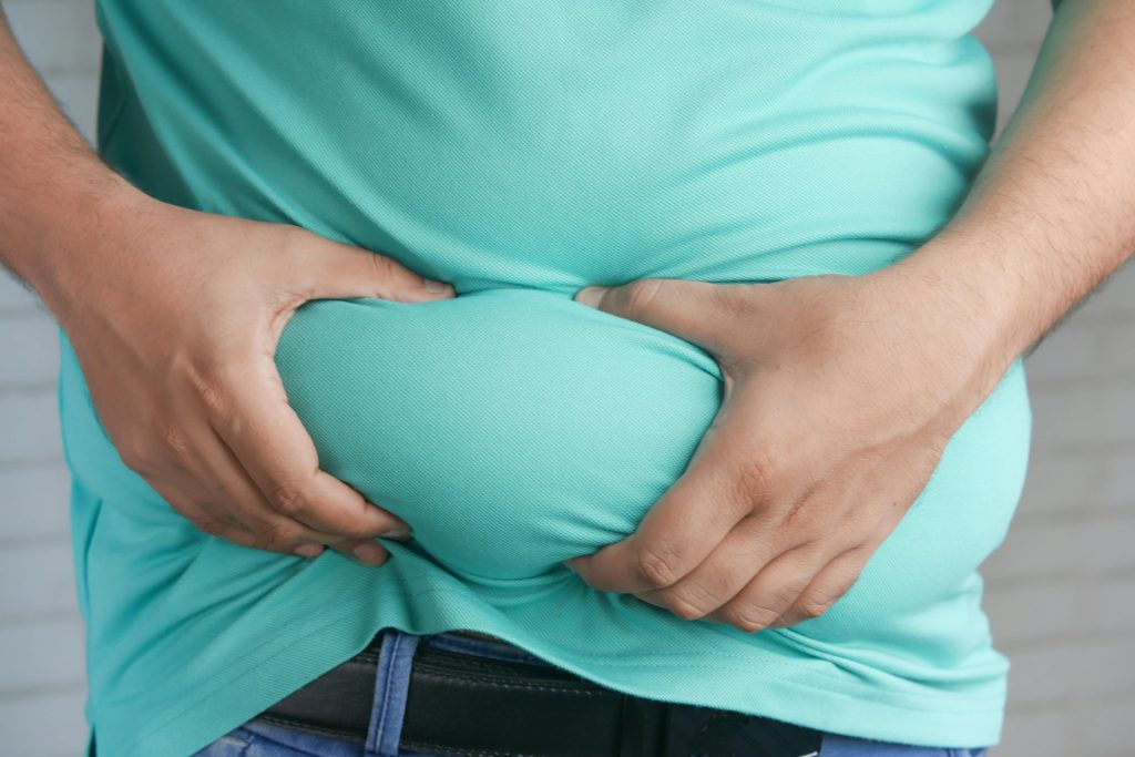 Person holding their belly
