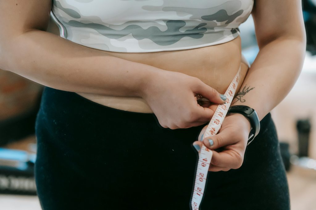 Person measuring waistline