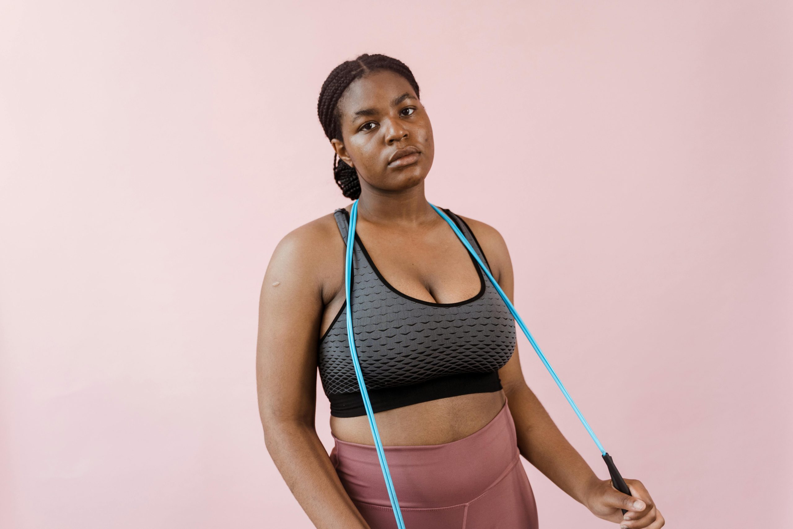 Person holding a jump rope on their shoulders