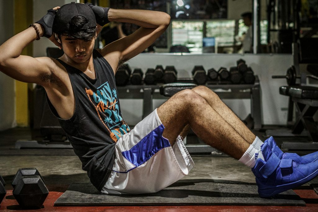 Man doing sit-ups in a gym