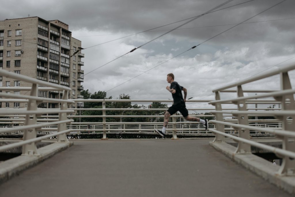 Man running across a bridge